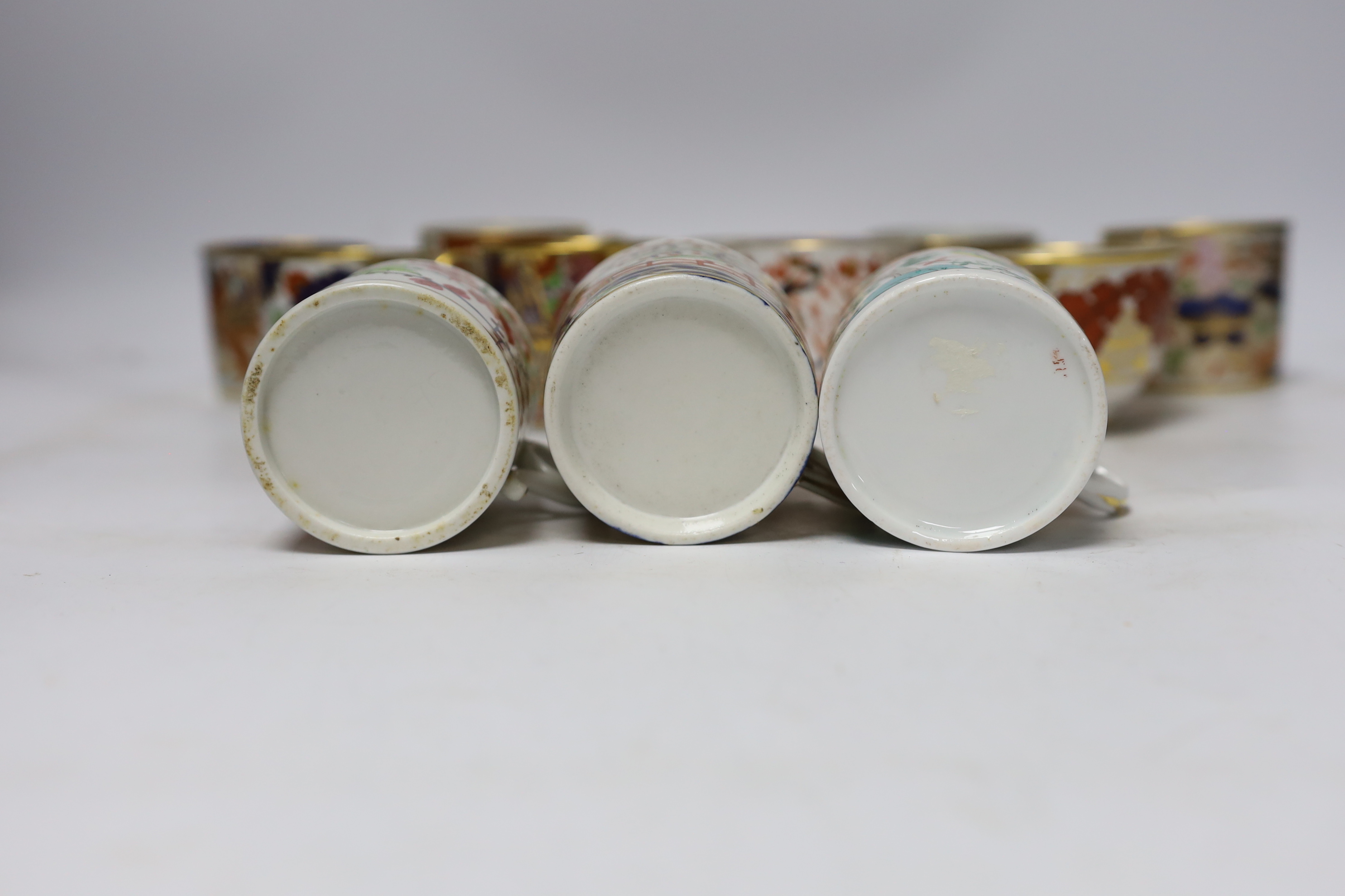 Twelve 1800-1820 English porcelain coffee cans and tea cups, including Imari pattern examples